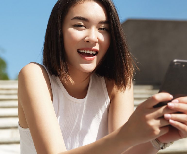 Girl outside texting on phone