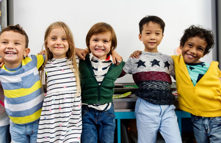 kids with arms wrapped around one another