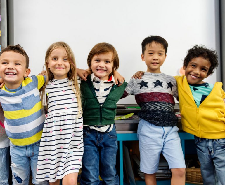 kids with arms wrapped around one another