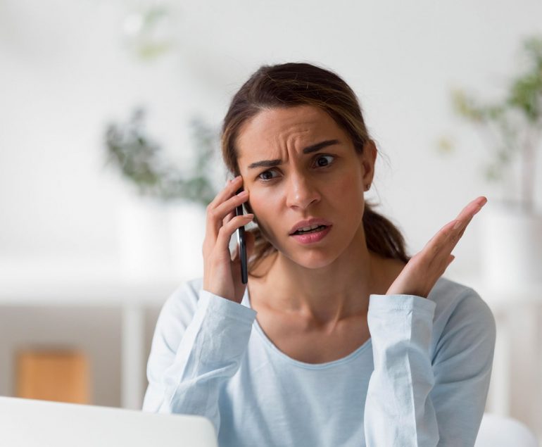 woman on phone frustrated